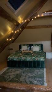 a bedroom with a bed with lights on the ceiling at Les Almadies private Jacuzzi in Villeneuve-les-Sablons