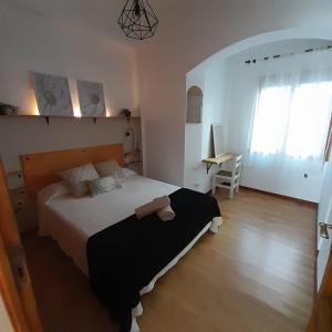 a bedroom with a large bed and a desk at Casa Cervantes in Granada