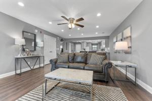 a living room with a couch and a ceiling fan at Free Daily Attractions including Silver Dollar City! Spacious, Centrally located, 2 pools in Branson