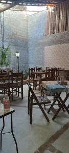 un grupo de mesas y bancos de madera en una habitación en Pousada Ribeirinha, en Aparecida