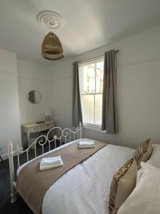 a bedroom with a bed with two towels on it at Stylish Ground Floor Apartment Nr Gloucester Docks, by Sauvignon Stays 