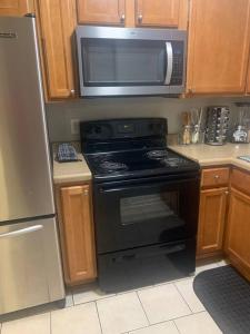 a kitchen with a black stove and a microwave at Welcome Home in Charlotte +24 photos