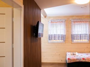 a bedroom with a bed and two windows at Aura Zawady in Popów