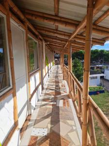 a wooden walkway on the side of a building at Hotel santa marta Melgar in Melgar