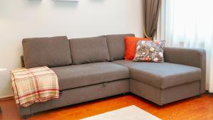 a brown couch with pillows on it in a living room at Central Duplex Gem near Taksim & Galata Port in Istanbul