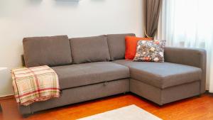 a brown couch with pillows on it in a living room at Central Duplex Gem near Taksim & Galata Port in Istanbul