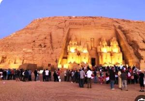 a large group of people standing in front of a building at Tut Amun in Abu Simbel