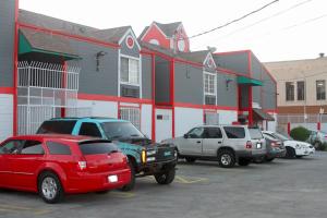 a group of cars parked in a parking lot at Broadway Inn Motel in Los Angeles