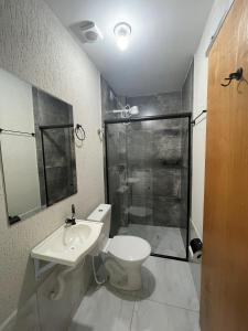 a bathroom with a toilet and a sink and a shower at Flat Completo Aparecida de Goiânia in Aparecida de Goiania