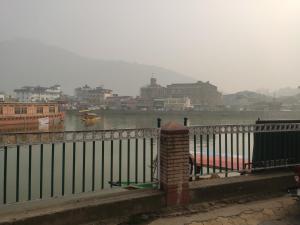 a fence with a view of a river and a city at Lake Boulevard Guest House in Durgjan