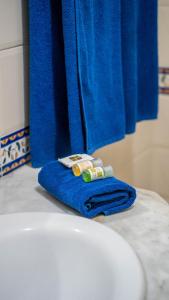 a blue towel sitting on top of a bathroom sink at HOTEL KAISER in Sousse
