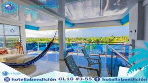 a hammock on the balcony of a house at Hotel la Bendición in Moñitos