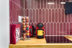 a counter with a coffee maker and a cup on it at Guestrust- Arc de Triomphe Corail in Paris