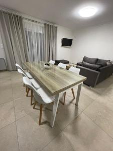 a dining table and chairs in a living room at TEGEA LUXURY SUITES Aphrodite in Tripolis