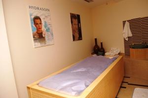 a bedroom with a bed and a poster on the wall at Aegeon Hotel in Karlovasi