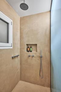 a bathroom with a shower with two bottles of wine at Crete - Heraklion Sea View Apartment 1 in Heraklio Town