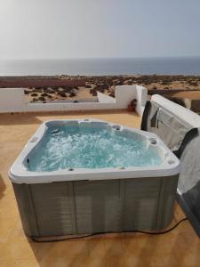 a hot tub with the ocean in the background at Riad Ocean Beach Douira in Agadir