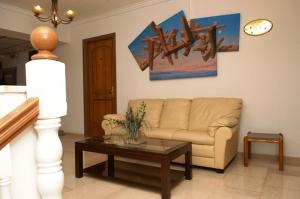 a living room with a couch and a coffee table at Aegeon Hotel in Karlovasi