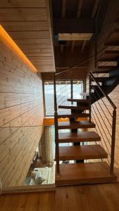 a wooden staircase in a room with a window at ARTYSUR LUX VILLAGE CASA 2 in Sierra Nevada