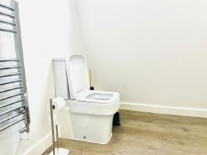 a bathroom with a white toilet in a room at Seaview apartment in Kent in Kent