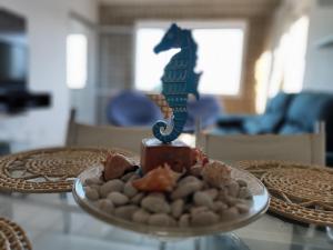 a plate with a figurine of a horse on a table at Temporada Beira-Mar Maceió in Maceió