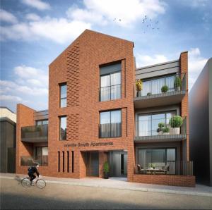 a person riding a bike in front of a brick building at Beautiful Penthouse In Bristol - new in Bristol