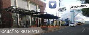 a view of a street with a building with umbrellas at Hotel y Cabañas Rio Mayo in Chachagüí