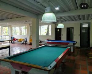 a pool table in the middle of a room at Hotel y Cabañas Rio Mayo in Chachagüí