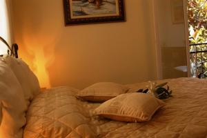 a bed with two pillows on it in a bedroom at Aegeon Hotel in Karlovasi