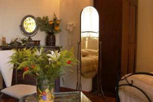 a living room with a vase of flowers on a table at Aegeon Hotel in Karlovasi