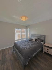 a bedroom with a large bed and a window at Luxury Downtown Townhome Unit 13 in Cleveland