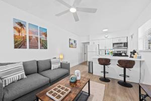 a living room with a couch and a kitchen at Comfy BNB #2 King Bed + Work/Travel + Beach 8 Min in Hallandale Beach