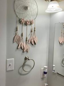 a bathroom with a dream catcher on the wall at Be our guest BOHO 2.0 in Charlotte