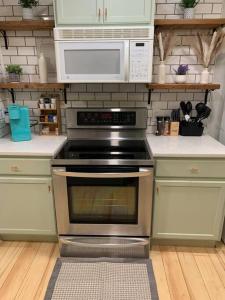 a kitchen with a stainless steel oven and microwave at Be our guest BOHO 2.0 in Charlotte