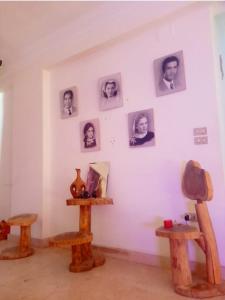 a room with a white wall with pictures on it at house in Maadi Degla in Cairo