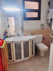 a bathroom with a sink and a toilet at house in Maadi Degla in Cairo