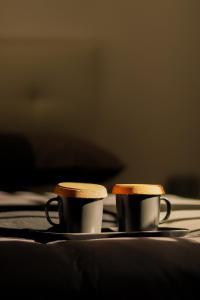 two coffee cups are sitting on a table at Alma House in Portici