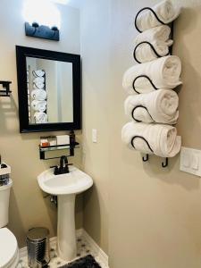 a bathroom with a sink and a pile of towels at Multi Family! 2 min walk to Beach! EV Charger! in Oceano