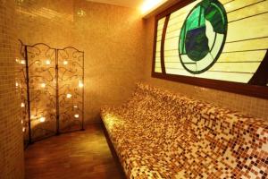 a bedroom with a bed with a window and lights at Aegeon Hotel in Karlovasi