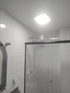 a bathroom with a shower with a glass door at Apto 227 a 4 km do aeroporto N B centro in Núcleo Bandeirante