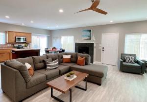 a living room with a couch and a table at Multi Family! 2 min walk to Beach! EV Charger! in Oceano
