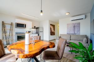 a living room with a wooden table and a couch at Casco View By Wynwood House in Panama City