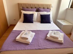 a bedroom with a bed with towels on it at Figueira da Foz Luxury Villa Suite Room in Buarcos