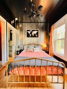 a bedroom with a large bed with a chandelier at Book Haven 2BR by fairgrounds/Blue Bell Creameries in Brenham
