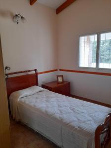 a bedroom with a bed and a window at Casa en Potrero de Garay in Potrero de Garay