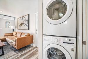 a living room with a washing machine and a couch at One bedroom retreat full kitchen/laundry 1GB Wi-Fi in Bonita