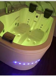 a white bath tub with lights in a bathroom at Hotel Casa Shami in Cusco