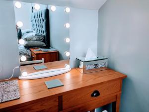 a dresser with a mirror on top of it at Seahawk Holiday Apartments in Cleveleys