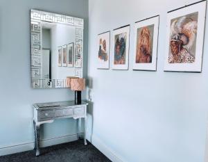a hallway with pictures on the wall and a table at Seahawk Holiday Apartments in Cleveleys