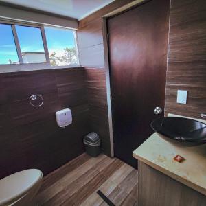 a bathroom with a sink and a toilet at Hotel Ocaso Marinilla in Marinilla